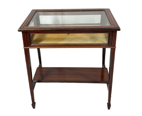 An elegant antique display table crafted from rich mahogany wood, wood inlay border and cut glass on square-cut tapered legs.