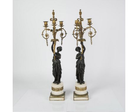 Superb pair of French antique Empire style patinated bronze candelabras, each featuring a female figure dressed in Neoclassic