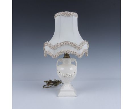 Beautiful glazed porcelain with a pedestal handled urn shape, completed by an elegant lamp shade. Marked with Manufacturers s
