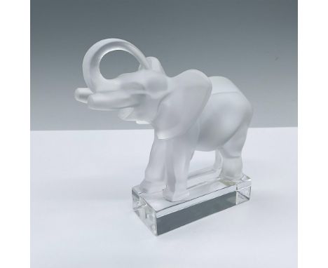 A frosted crystal figure of an elephant with trunk raised up. Attached to a clear crystal base. Lalique France etched on the 