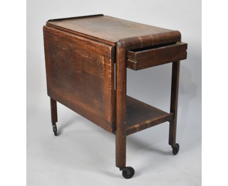 An Oak Single Drop Leaf Trolley with Stretcher Shelf and Sliding Drawer, 65cm wide 