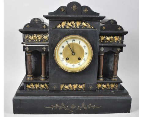 A French Black Slate Mantel Clock of Architectural Form with Gilt Highlights and Reeded Columns with Pendulum and Key, 40cms 
