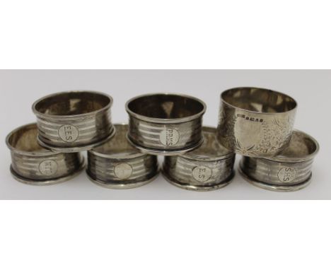 Samuel M. Levi, A set of six silver napkin rings, Birmingham 1922, together with a chased silver napkin ring, Sheffield 1877,