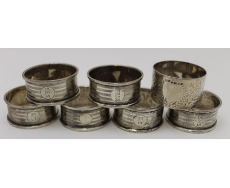 Samuel M. Levi, A set of six silver napkin rings, Birmingham 1922, together with a chased silver napkin ring, Sheffield 1877,