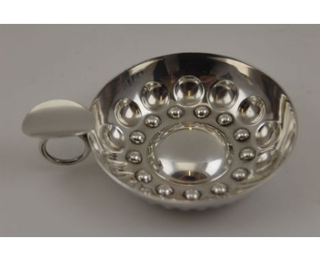 A French white metal taste vin, embossed decoration, ring handle with thumbpiece, the bowl 8.5cm in diameter, 62g, bears stam