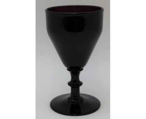 A 19th century amethyst rummer, having a double ogee bowl on a collar, knopped stem and cushioned basal knop, leading to a sh