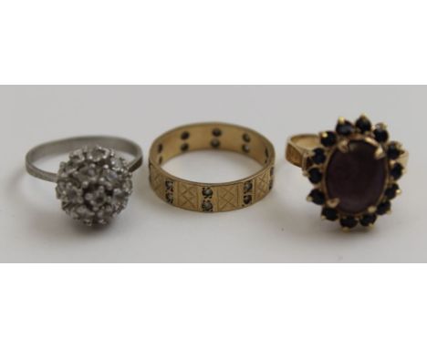 A 14k gold stone set ring, together with a 9ct gold eternity ring, and a cluster ring (3) 