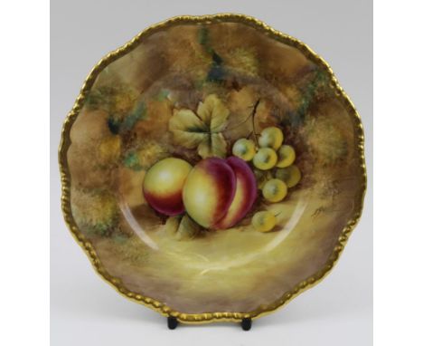 A Royal Worcester bone china cabinet plate, hand painted fruit decoration against a mossy bank, signed J. Smith, gilded rim, 