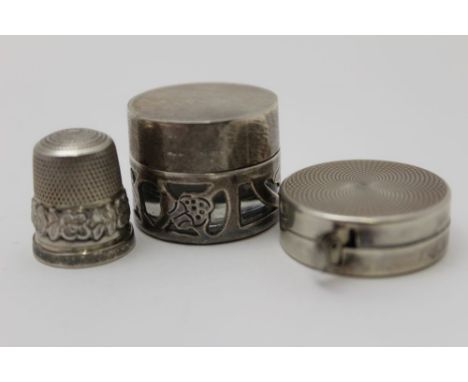 A silver cased tape measure, stamped .925, engine turned case, 3cm in diameter, together with a cast silver thimble, Birmingh