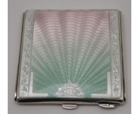 W.I. Broadway & Co. A silver and enamel powder compact, the front decorated with an opalescent guilloche panel of radiating s