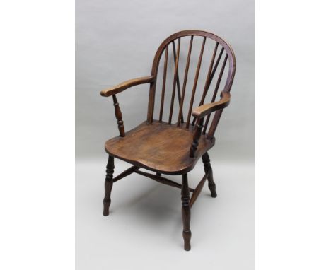 A late 19th-century country kitchen armchair, with hoop and stick back and well figured elm seat, the rear block stamped H S,