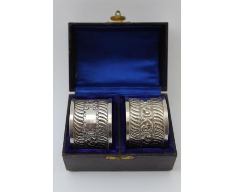 John Edward Wilmot, A pair of late Victorian silver napkin rings, chased canthus leaf decoration, blind cartouche, Birmingham