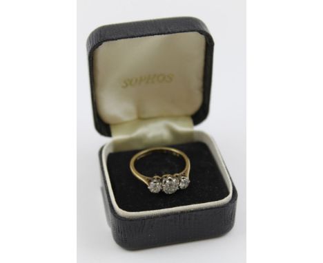 A three diamond ring, brilliant cut, larger stone to centre flanked by two smaller stones on an 18ct gold band, ring size; L 