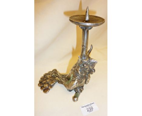 Sculpture of a horned cockerel wearing a tie, formed as a candlestick. Artist's monogram signature CR, dated as 1977, and mad