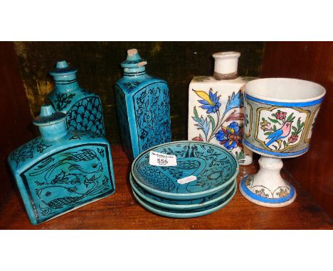 Three Iznik pottery blue glazed jars with lids, three similar dishes, a flask and a goblet