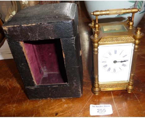 19th c. gilt brass carriage clock having four column body (crack to glass) with leather case and key, 6" tall