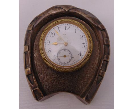 A desk clock of circular form mounted in a hallmarked silver horseshoe frame, Birmingham 1902