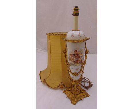 A Sevres style porcelain and gilt metal table lamp decorated with putti and flowers, to include shade, 58.5cm (h)