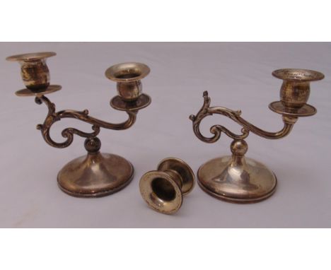 A pair of white metal two light candelabra on raised circular bases, 14cm (h) one A/F