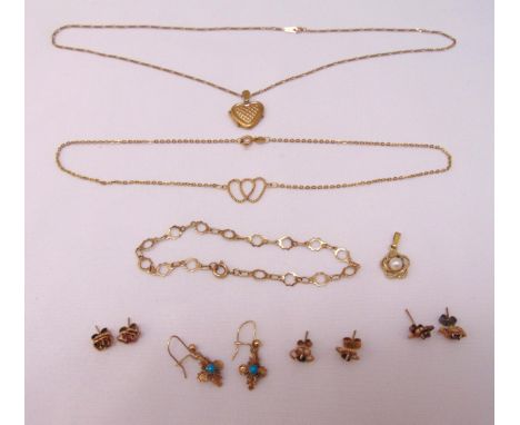 A quantity of 9ct gold jewellery to include four pairs of earrings, a bracelet, a locket on a chain, a double heart pendant n