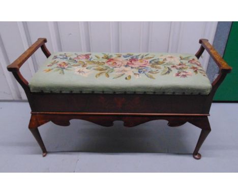 A late Victorian mahogany rectangular bench, hinged tapestry top, two side handles inlaid with flowers and leaves, on four ca