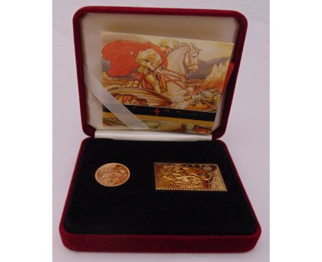 2001 gold sovereign and a gilded silver gilt stamp ingot in presentation packaging