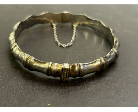 Silver bangle with safety chain 