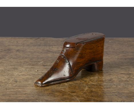A 19th Century carved wooden shoe snuff box, with pin decoration to front and sole, sliding lid —4in. (10cm.) long (old repai
