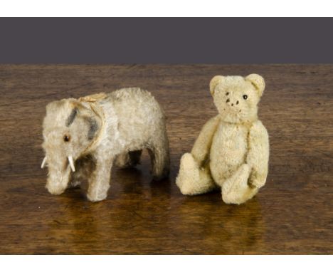 A Steiff miniature teddy bear,  with light golden mohair, black glass eyes, remains of black stitching, swivel head and joint