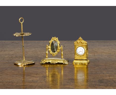 Gilt metal dolls’ house items, a dressing table mirror —2in. (5cm.) high (glass cracked), a mantel clock with enamel dial and