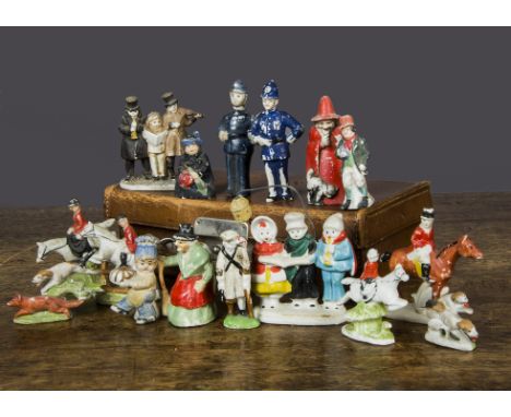 Bisque people cake decorations, three carol singers with lamp on metal wire —3in. (7.5cm.) high, a smaller example, two polic