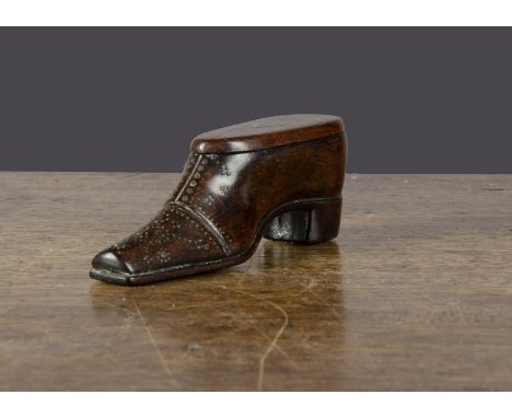 A 19th Century carved wooden shoe snuff box, with pin decoration to front and sole, hinged lid with brass lozenge plaque —4¼i