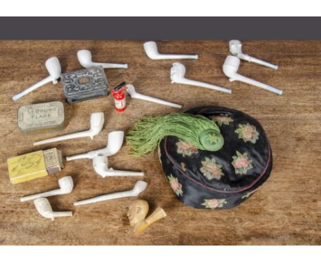 A silk smoking hat, decorated with applied roses and a green tassel —20in. (51cm.) circumference inside; a pottery pipe of Ca