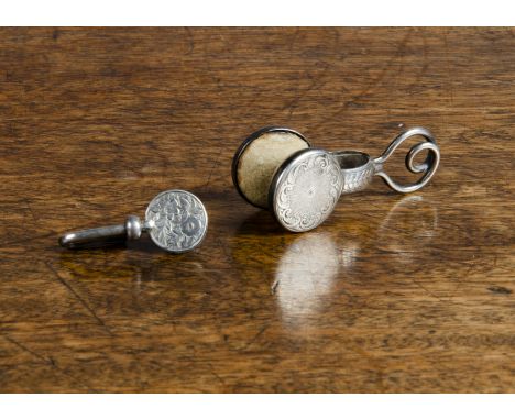 A 19th Century white-metal napkin clip, with loop holding a steel-reinforced clip with acanthus leaf and engine-turned decora