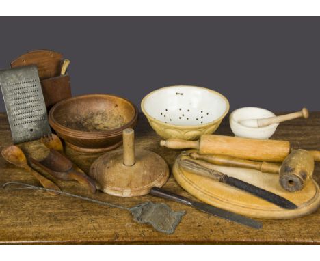 Various kitchenalia, including an oval breadboard, a rolling pin, mortar and pestle, vegetable maskers, mixing bowl, wooden m