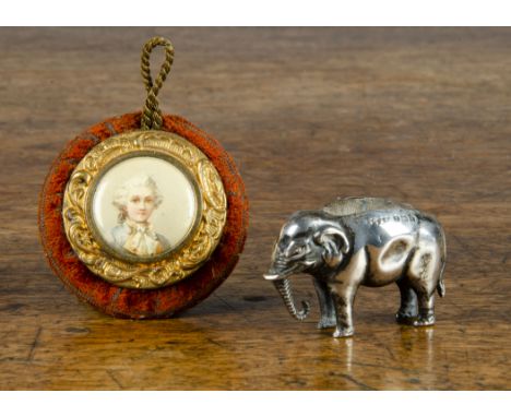 An English silver elephant pincushion,  Birmingham, 1906 —2in. (5cm.) long (dented); and a handbag mirror/pincushion with gil