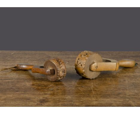 Two wooden roller butter moulds, one carved with an acorn, leaves and flower —6½in. (16.5cm.) long; and the other carved with