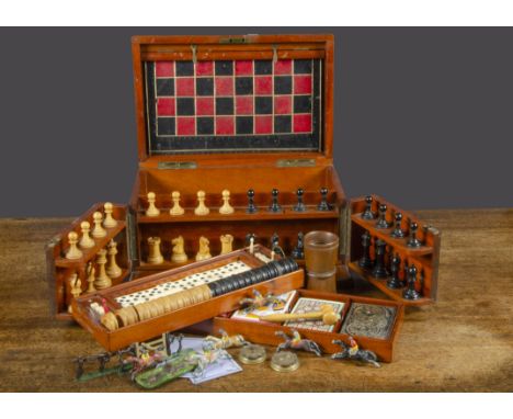 A late 19th Century mahogany games compendium, with turned wooden chess set, draughts, dominos, lead race horses, two brass P