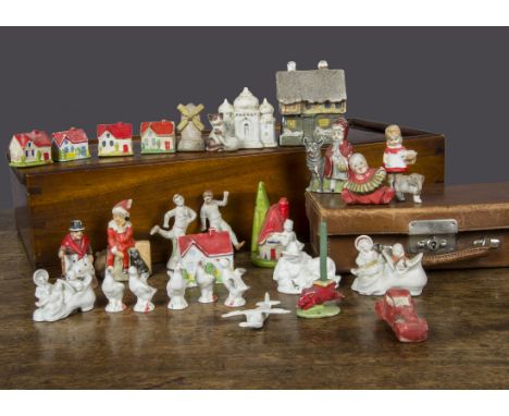 Various bisque cake decorations, Dick Whittington, a seated baby playing an accordion, a frosted roof house —3in. (7.5cm.) hi
