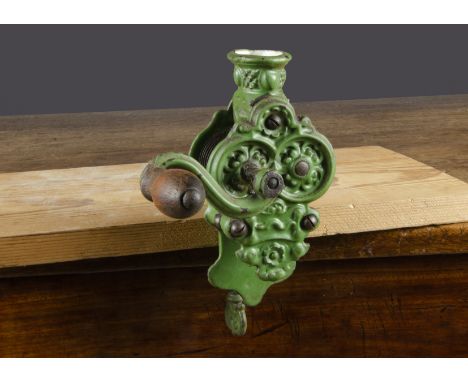 A late 19th Century cast-iron table top runner bean shredder,  painted green with turned wooden handle —8½in. (21.5cm.) high 