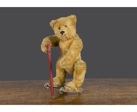 A rare Bing clockwork skating teddy bear circa 1912, with blonde mohair, black boot button eyes, pronounced muzzle, black sti