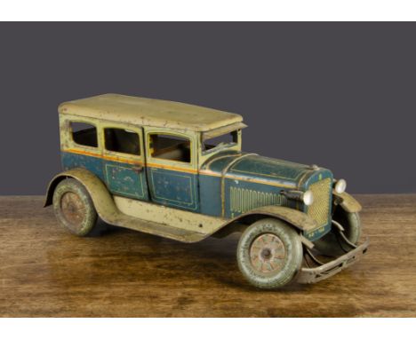 A Karl Bub clockwork tinplate Limousine,  lithographed teal and pale green with yellow lining, opening passenger doors, brown