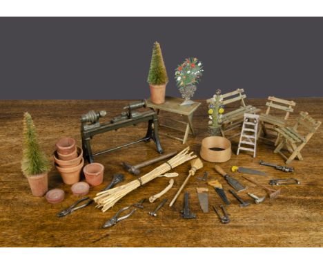 Dolls’ house and miniature tools and gardening, a German cast-iron engineering lathe, painted green and stamped 'Germany' —5¾