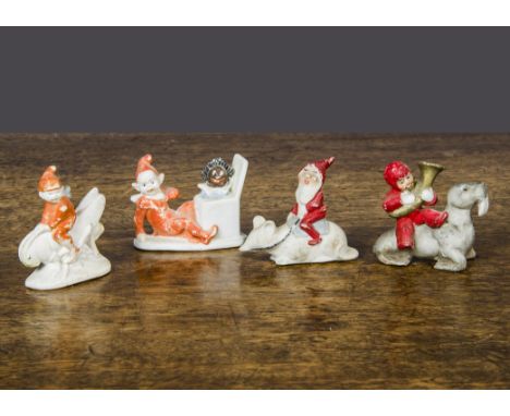 Unusual bisque cake decorations, a dwarf riding a mouse —2¼in. (5.5cm.) long, a red painted unfrosted snow baby playing a bra