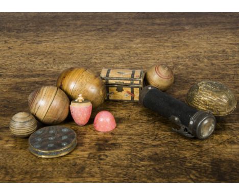 The Smallest Doll in the World, a pegged-wooden doll in a turned wooden pink painted egg —1¼in. (3cm.) high; a cardboard waln