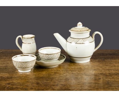 An English pearlware toy part tea service,  painted with sepia trellis pattern borders comprising teapot and a cover, two tea