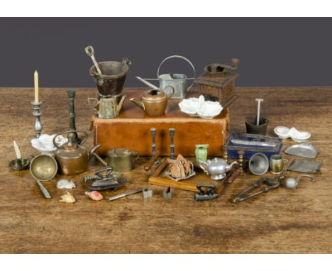 Dolls’ house kitchen equipment, including toast rack with toast, a coffee grinder, an oak tray, three kettles, iron on trivet