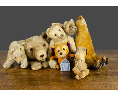 Various teddy bears and soft toys, a Steiff 1950s bear on all fours with button —8in. (20.5cm.) long; an Omega bear nightdres