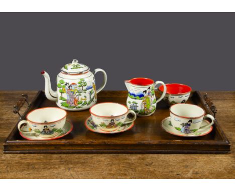 An enamel part tea set with Japanese scenes,  cream ground with brightly coloured traditional figures in landscapes, comprisi