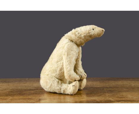 A small early Steiff polar bear circa 1912,  with white mohair, tiny black boot button eyes, remains of black stitched nose a